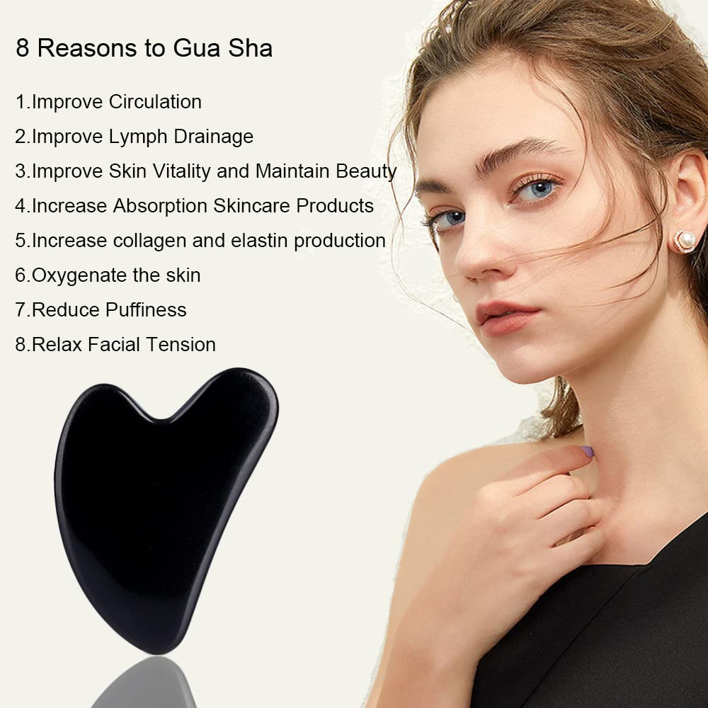 Heart-shaped black obsidian stone being used for lymphatic drainage massage